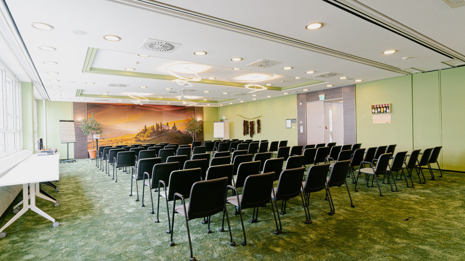 Tagungsraum Toskana im Smartvillage Bogenhausen mit Kinobestuhlung und Wandbild im mediterranen Stil.